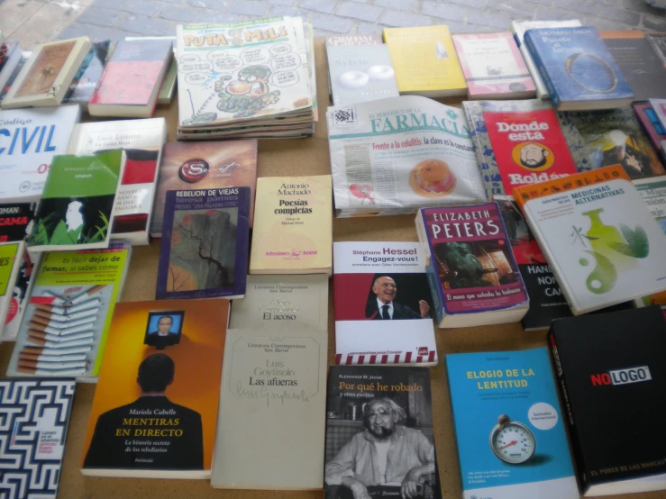 the table is full of many books and magazines