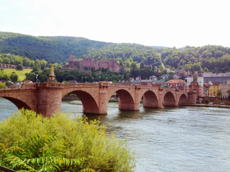 a bridge over a river between a group of buildings