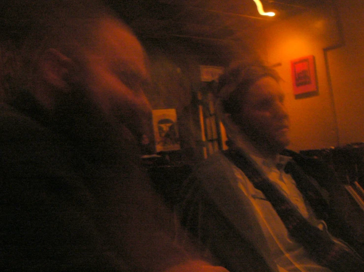 two men with blurry light in a dark room