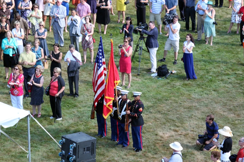 a military ceremony at a military event with a pographer and an audience