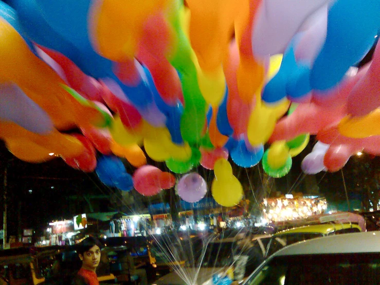 a bunch of colorful balloons flying in the air