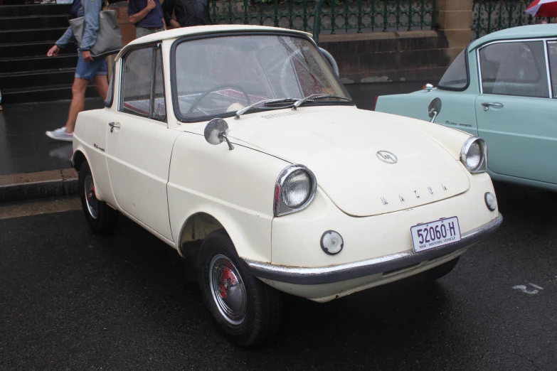 a white car that is parked on the street