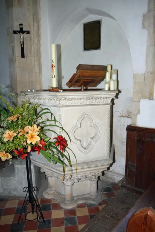 a church alter with candles, flowers and flowers in front