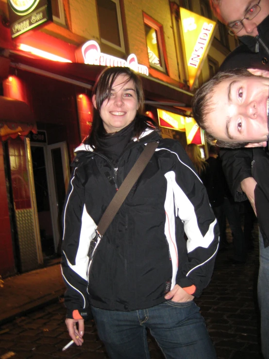 a man and woman smiling as they pose for the camera