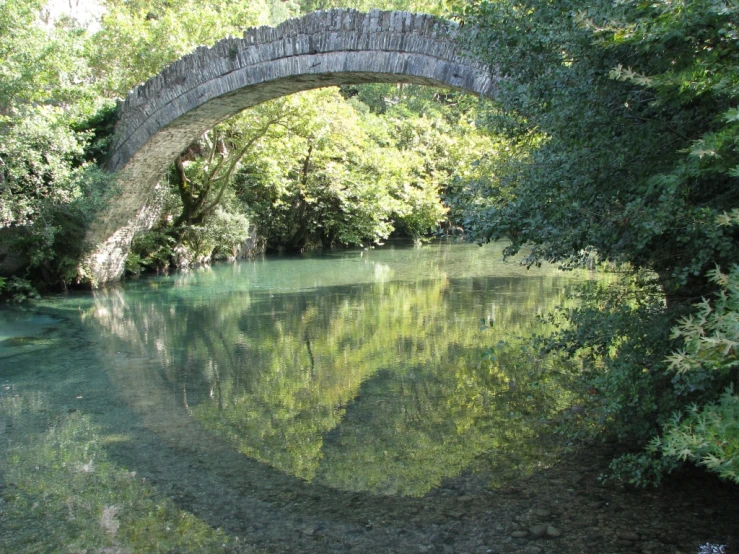 an old stone bridge over a river