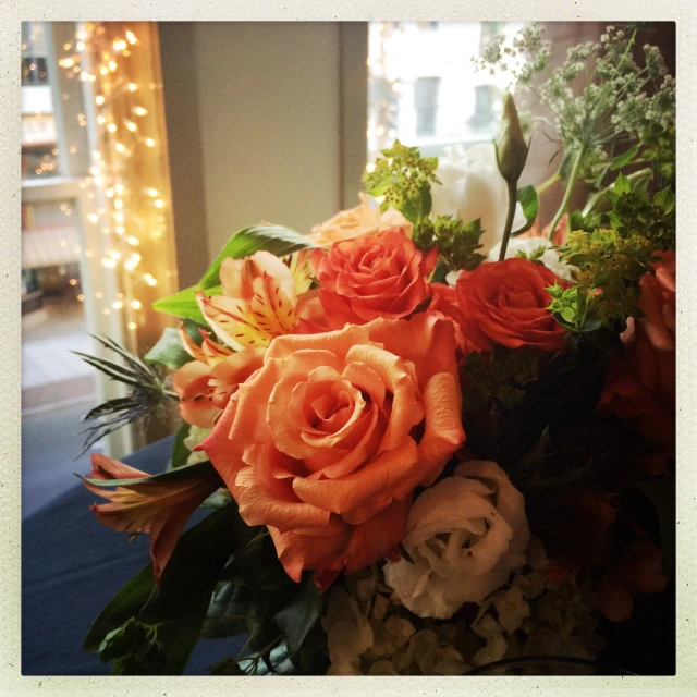 an arrangement of orange and white flowers