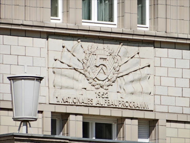 the facade of a large building with a symbol on it