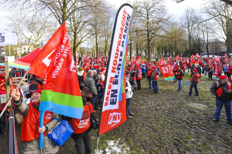 a group of people are gathered holding flags