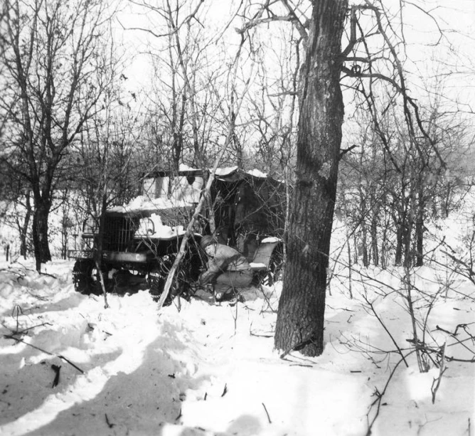 a vintage black and white pograph of a tractor in the snow