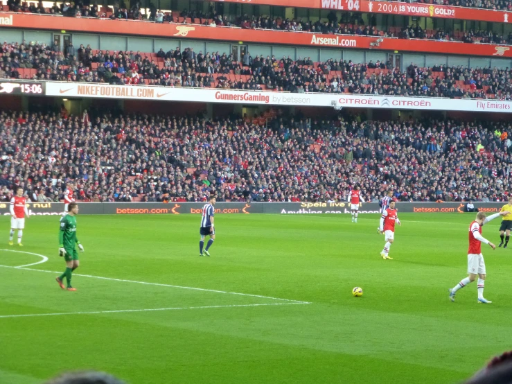 soccer game being played in large stadium on grass