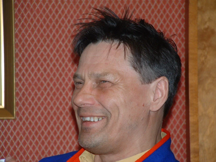 a close up of a person wearing a jacket and smiling