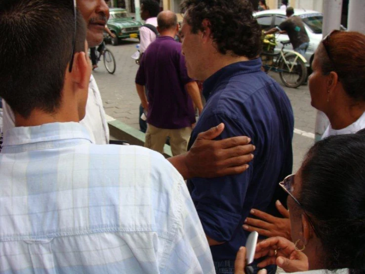 a group of people are huddled together near the street