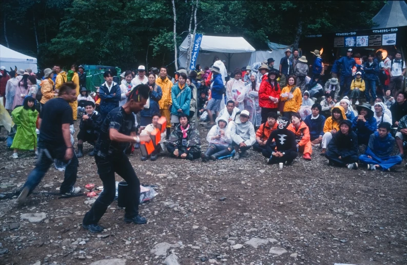 a crowd of people gathered around each other at a festival