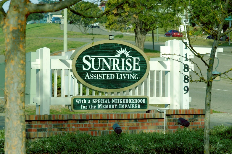 a sun rise assisted haven sign in front of a gate