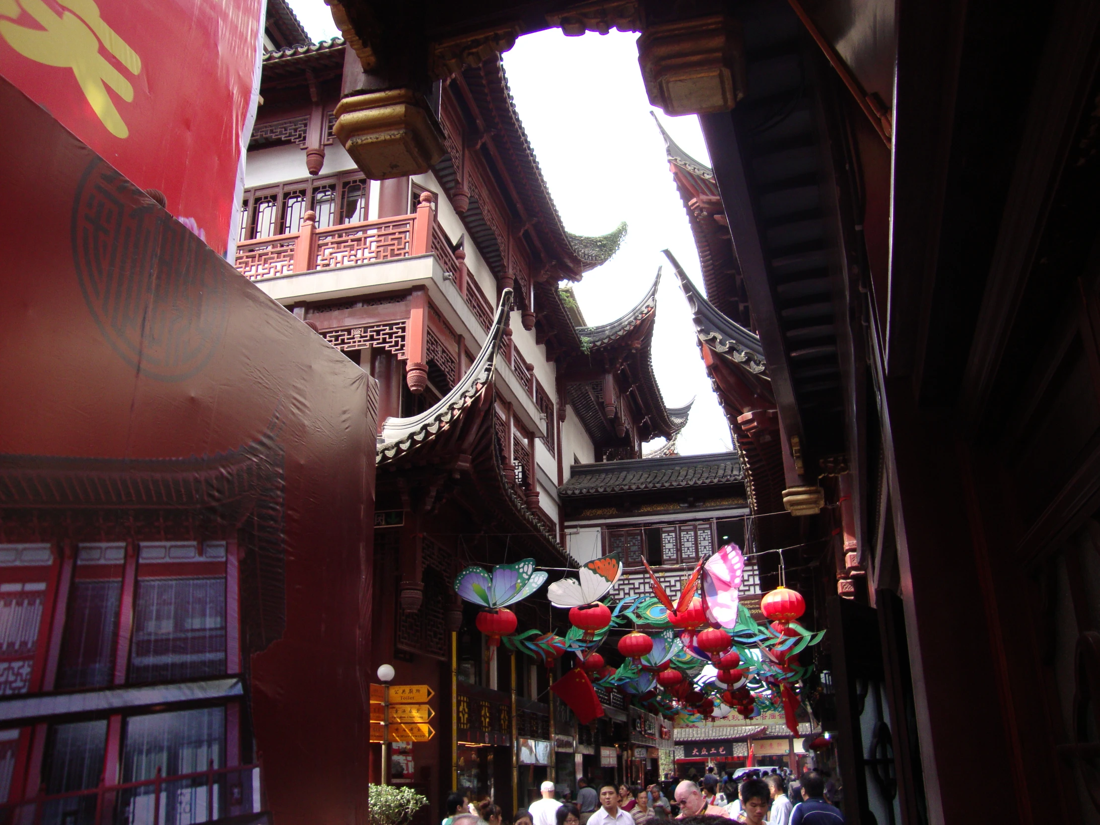 the hanging decorations at the street entrance show people and animals