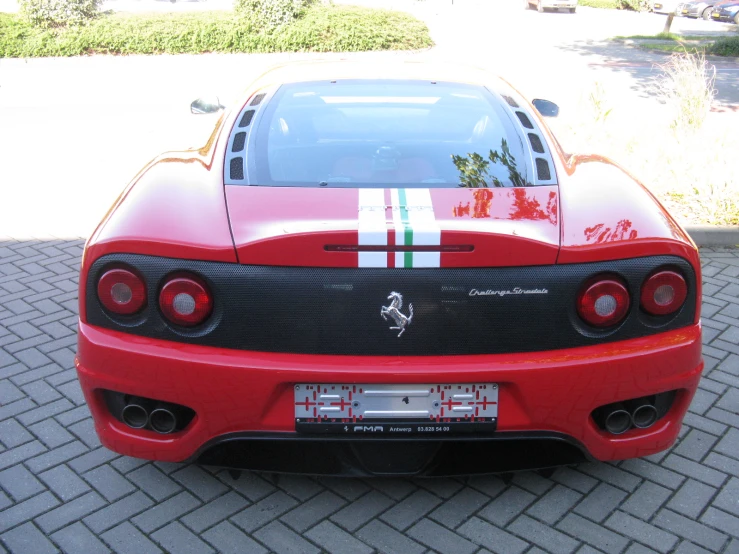 a ferrari sports car that has stripes painted on the front