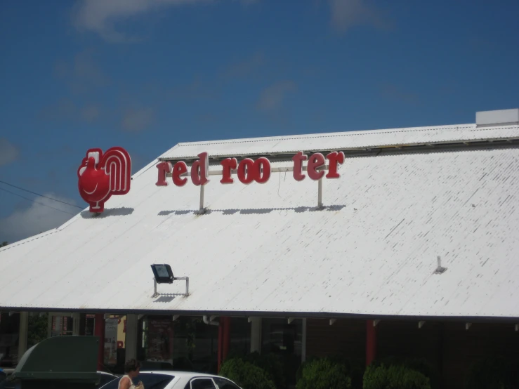 a restaurant with red food signs over the roof