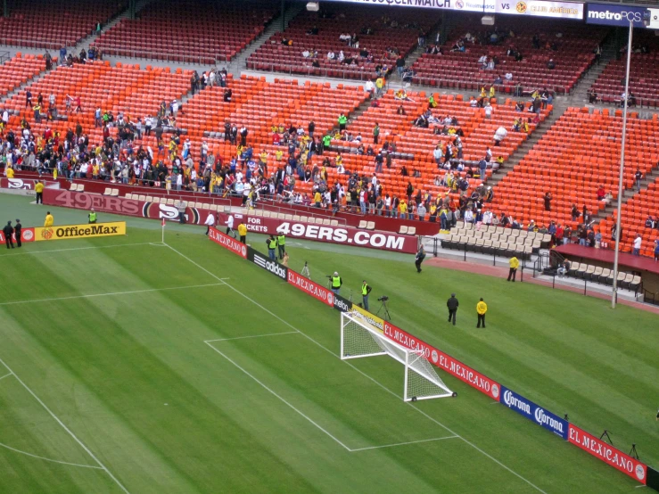 a soccer field surrounded by a crowd of fans