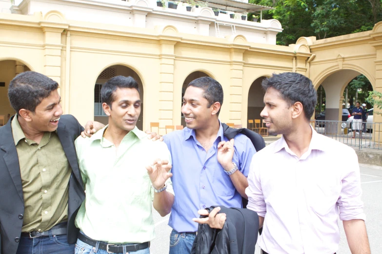 four men talking outside an office building