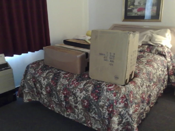 two boxes stacked on top of the bed