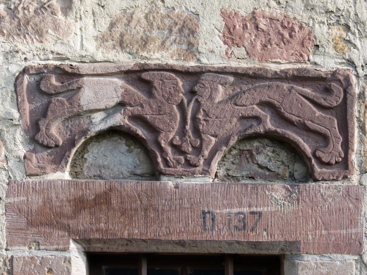 a stone structure with four horse heads on it