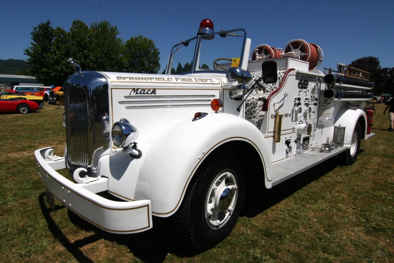 this fire truck is white in color and has engine on