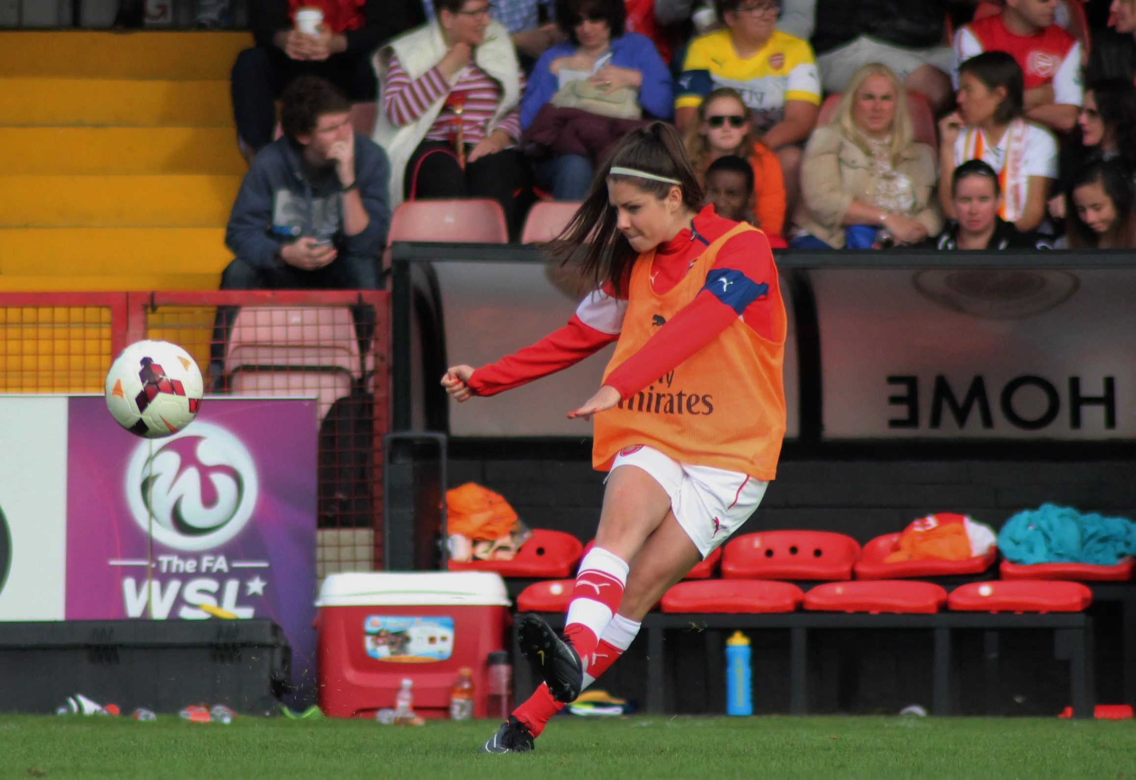 a soccer player kicking the ball during a game