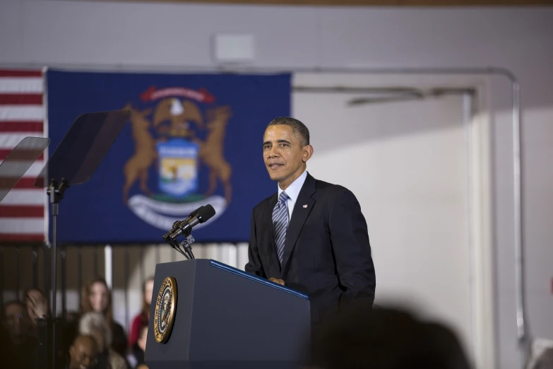 the president is standing at a podium and giving a speech