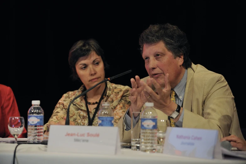 a woman and man are talking at a table