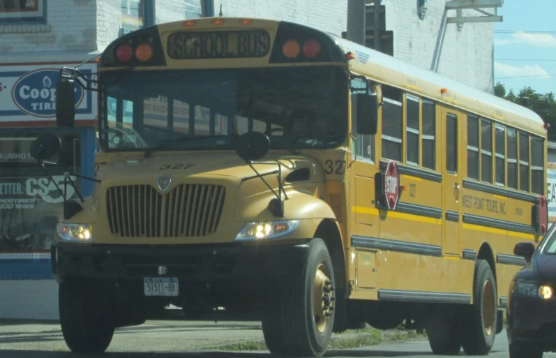 two yellow school buses on a city street