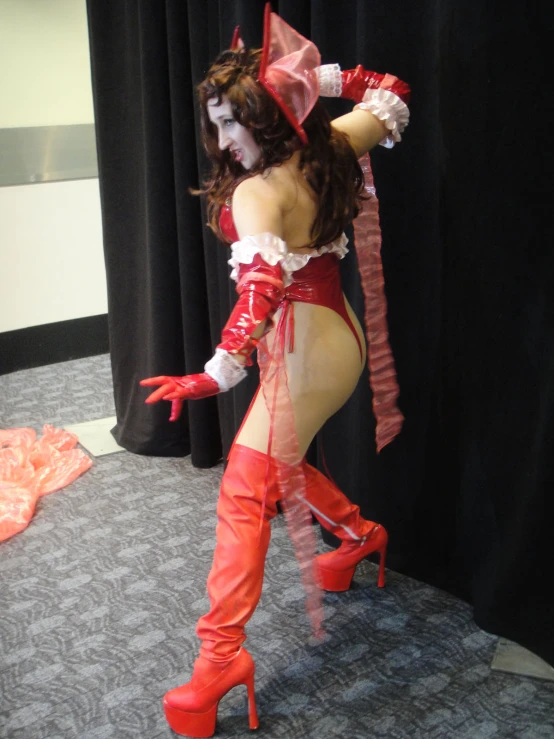 a woman in red boots is standing on the carpet