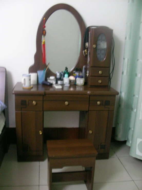 an elegant wooden dressing table has a mirror