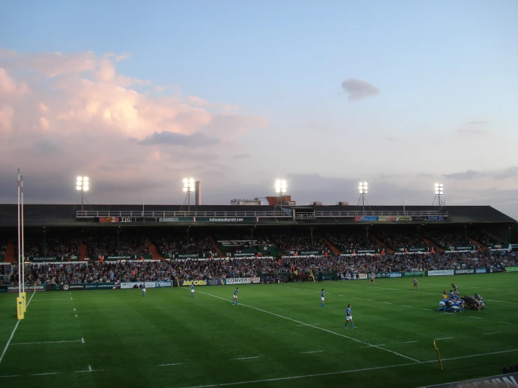 a soccer stadium filled with people during sunset