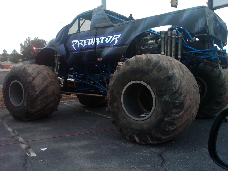 a large truck with very big tires parked on a lot