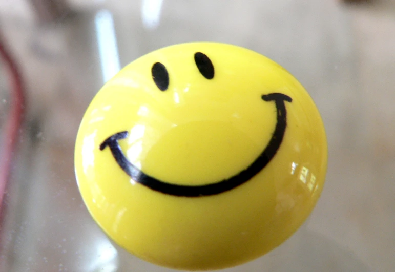 a yellow smile drawn on a glass surface