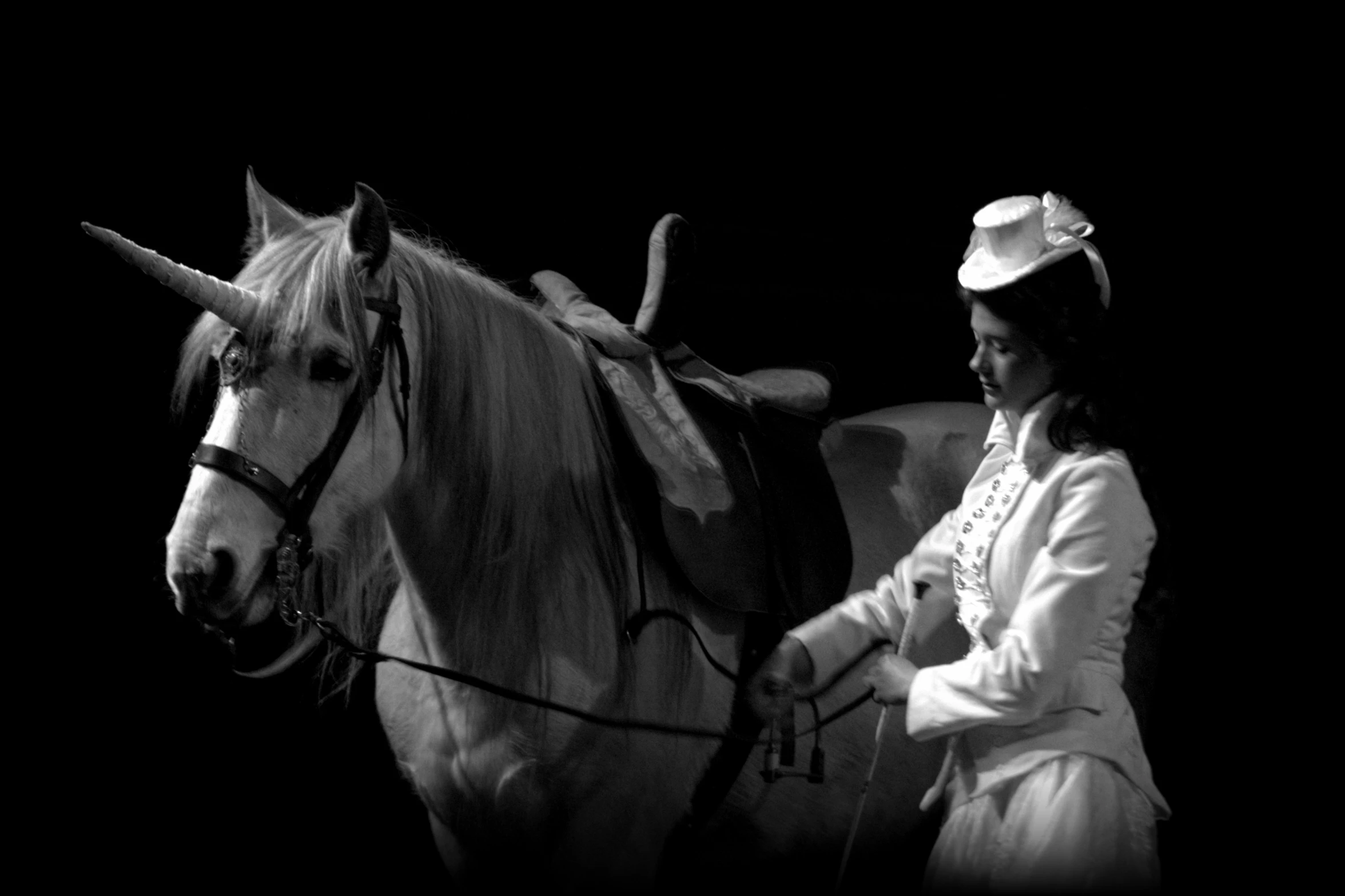 the girl is holding on to a white horse