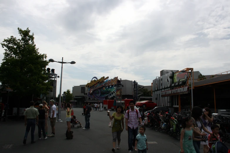 a group of people are walking around the street