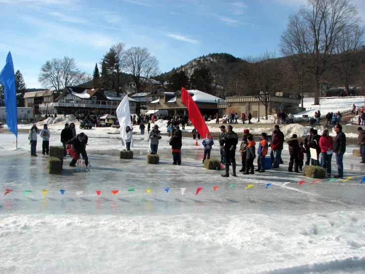 people standing around with flags on a frozen lake