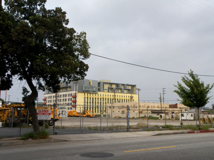 large yellow building next to an empty road