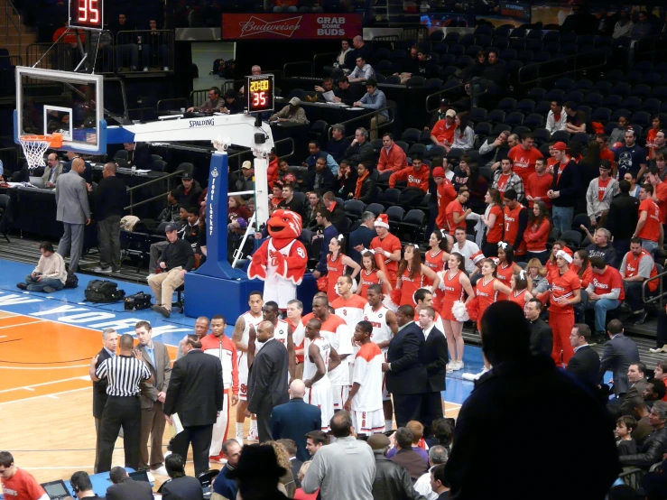 a large group of people are gathered in an arena