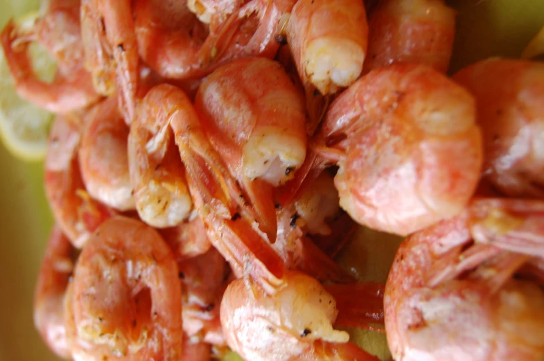 pieces of cooked shrimp on a yellow plate