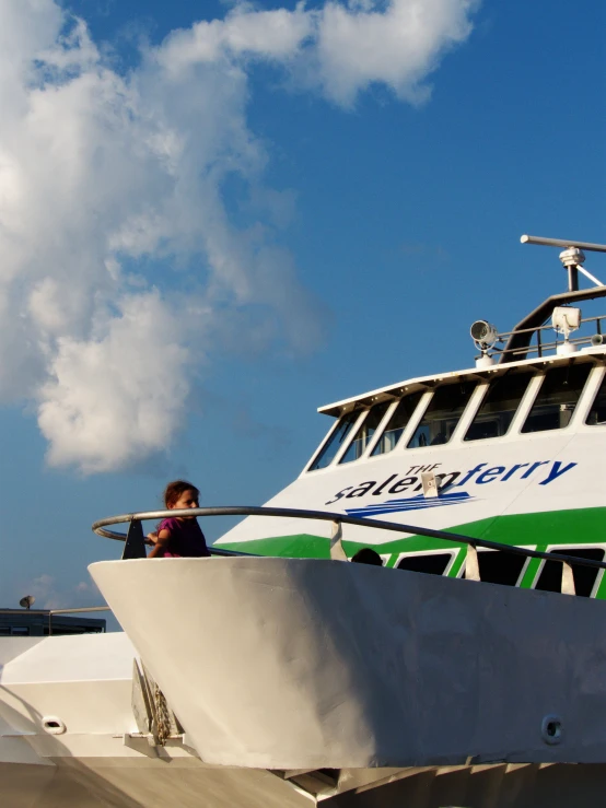 there is a boat that has people standing on the deck