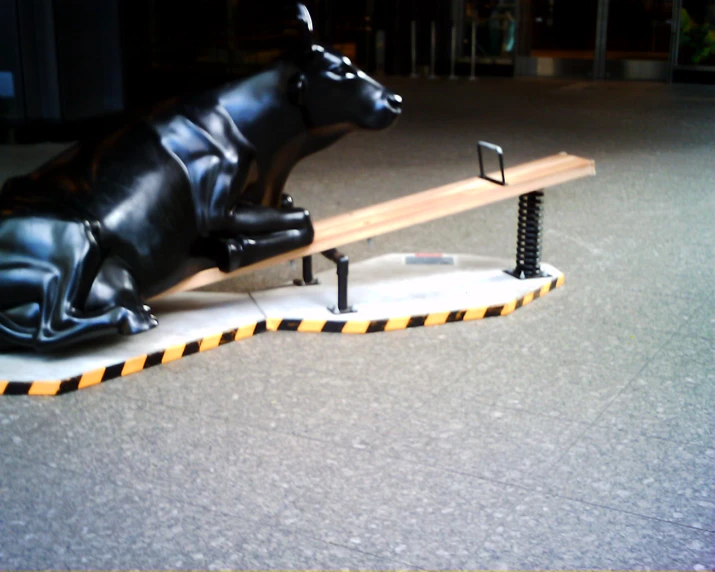 a statue of a bull laying on a table