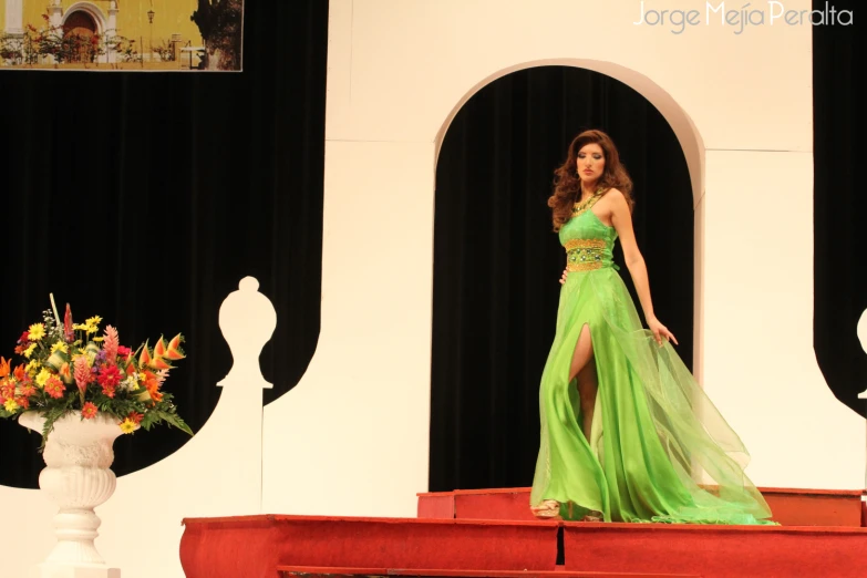 woman walking down a stage in a dress