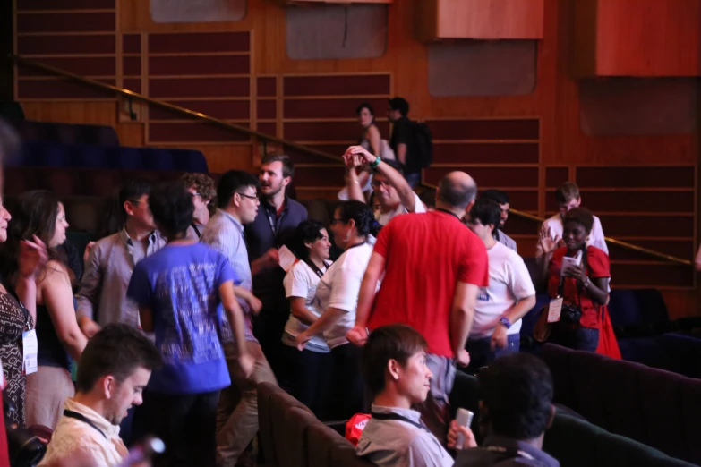 a crowd of people in a large lecture hall