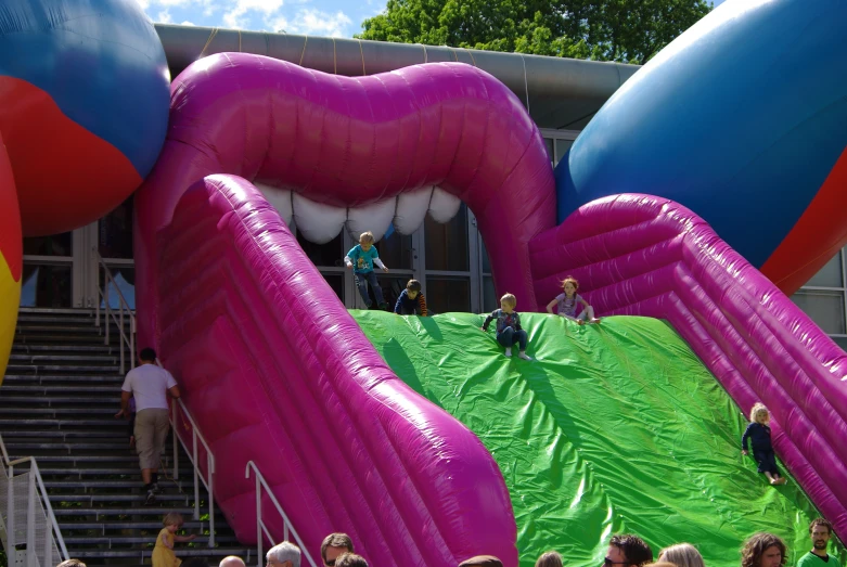 a group of people in a building with several large inflated items