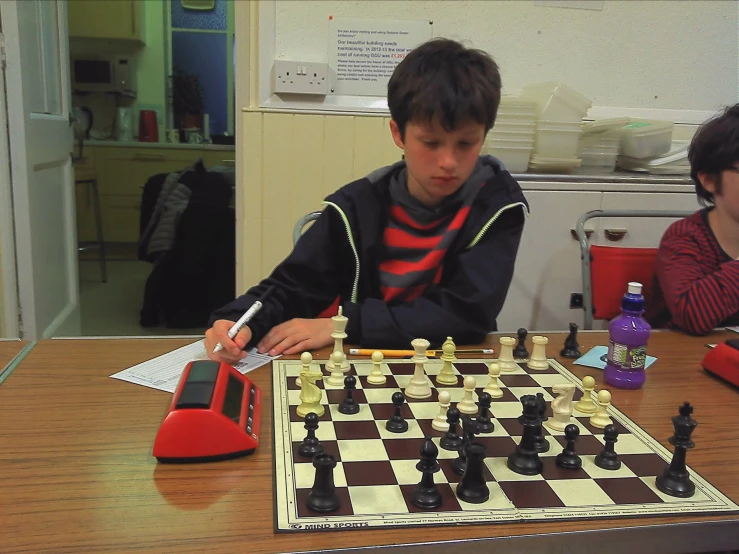 a  playing chess in an office cubicle