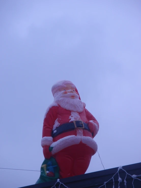 a large inflated santa claus in a city