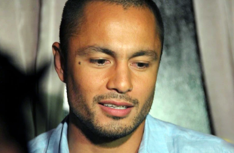 a close up view of a man wearing a blue shirt