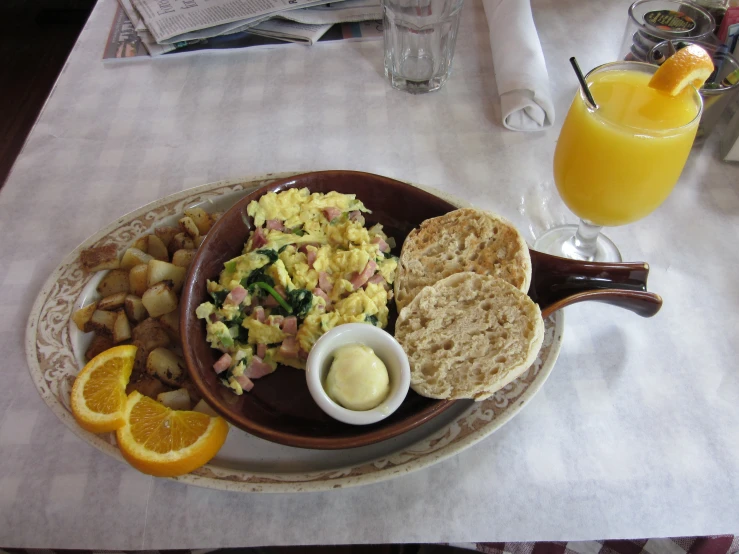 a plate full of food, including toast and orange juice